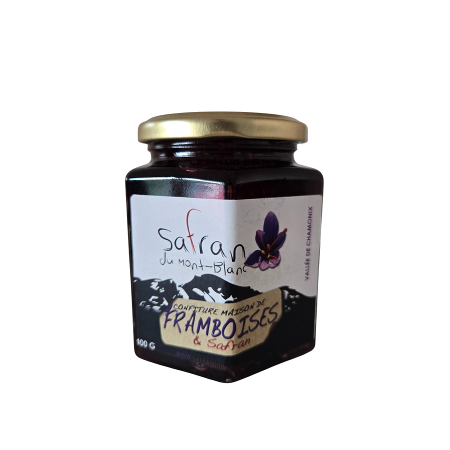 Jar of raspberry jam with a visible brand label on a white background