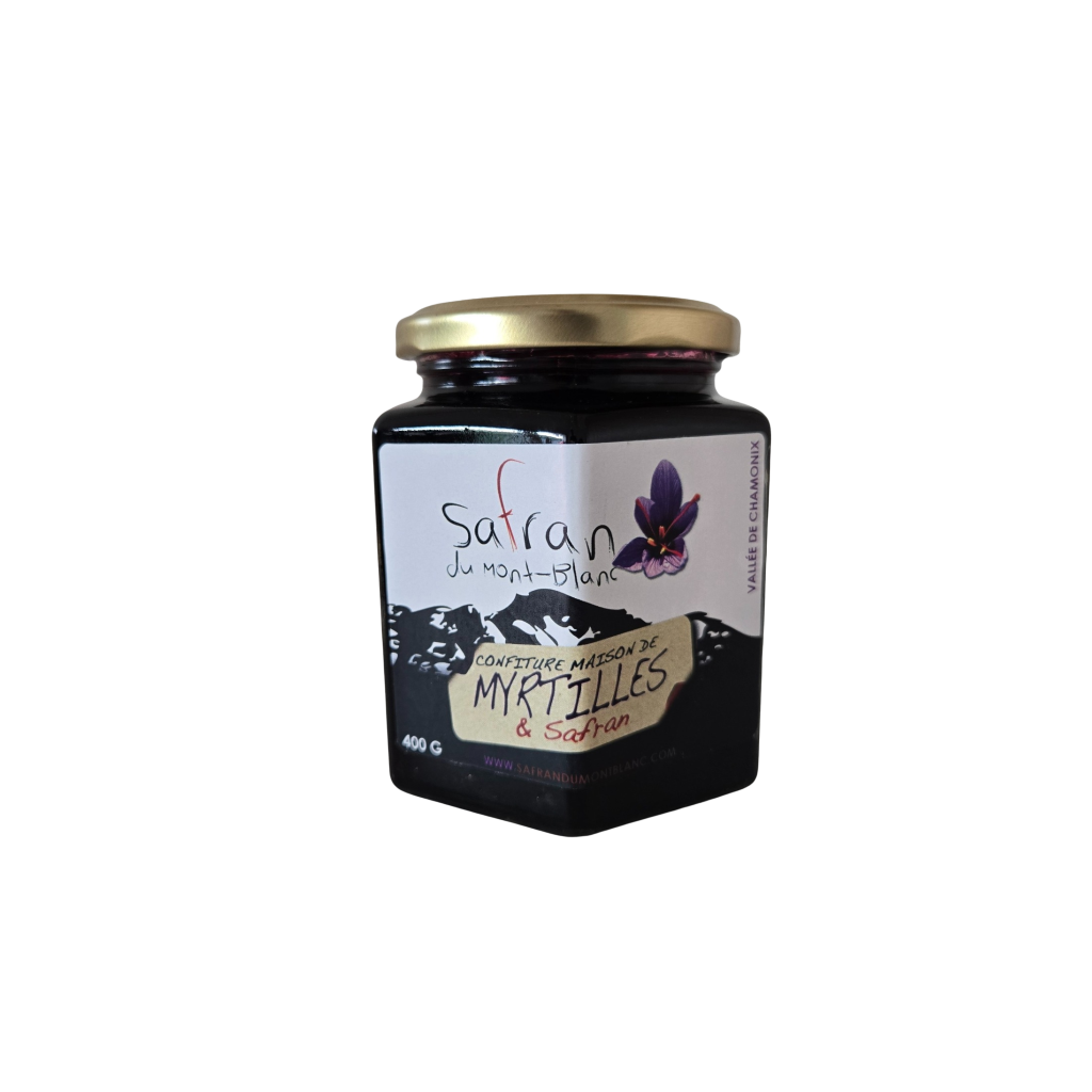 Jar of saffron and blackberry jam with a gold lid on a white background